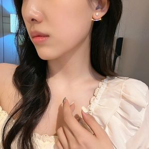 Minimalist silver needle geometric earrings with zircon pavé shown on a female model