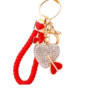 Red and gold heart keychain with rhinestones and arrow on a woven rope strap