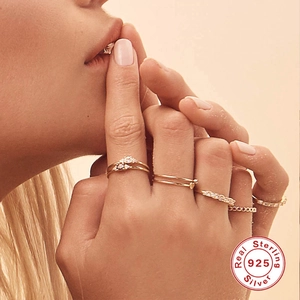 925 Sterling Silver layered ring set featuring minimalist bands and diamond accents