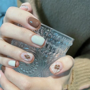 Close-up of short press-on nails with sweet rabbit designs and green plaid patterns