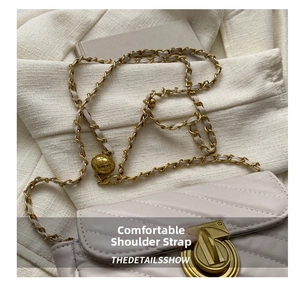 Close-up of quilted leather crossbody bag with gold chain and spherical adjustment buckle