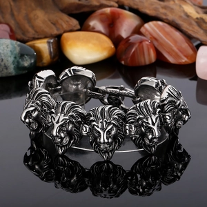 Macro detail of men's stainless steel lion head bracelet with vintage punk carving