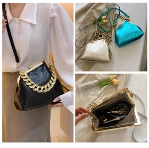 Detail showing the spacious interior and chunky gold chain of this vintage frame bag