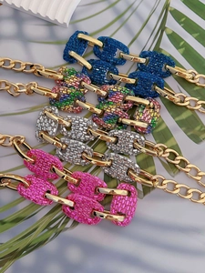 Detailed view of rhinestone embellished pig nose link necklaces in multiple colors
