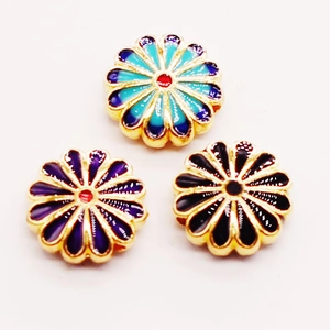 Detailed macro of enamel cloisonné sunflower charms with colorful gold plating