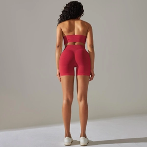 Macro detail of red seamless ribbed knit texture on high-waist yoga shorts and sports bra