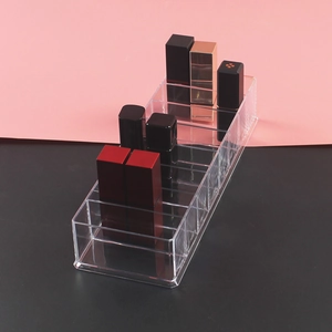 Macro view of clear acrylic lipstick organizer with multiple compartments and a sleek finish