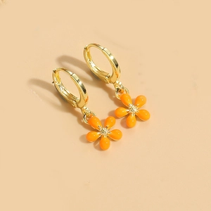 Macro detail of the orange enamel floral earring with gold-plated core and petal texture
