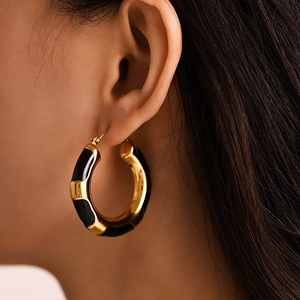 Fashionable gold-plated stainless steel hoop earrings with black enamel leopard design