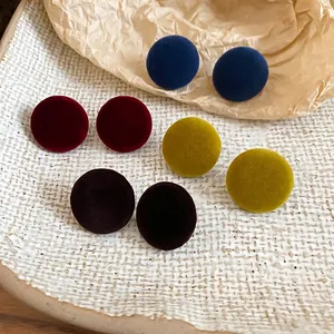 Set of four velvet round stud earrings in navy, burgundy, mustard and brown hues