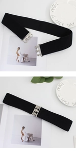 Detail of black elastic corset belt featuring three sets of silver metal buckles for women