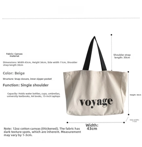 Detail view of large beige canvas tote bag showing size specs and metal snap button closure