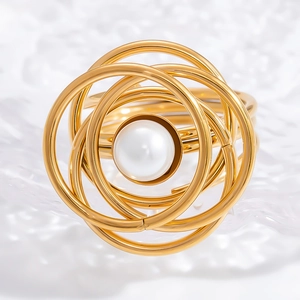 Elegant gold stainless steel ring with a white pearl in a unique spiral vortex design