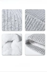 Detailed view of grey knit beanie with thick white thermal fleece lining for winter warmth