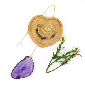 Hanging suncatcher with purple agate slice and crystals in a golden crescent moon frame