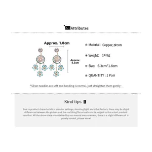 Detailed view of long flower petal tassel earrings with gold plating and zircons