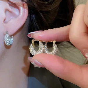 U-shaped gold plated earrings with sparkling white cubic zirconia stones for women