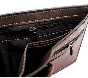 Macro view of dark brown leather wallet interior featuring double zippers and contrast stitching