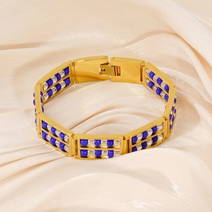 Macro view of gold-plated titanium steel bracelet featuring abacus-style blue beads