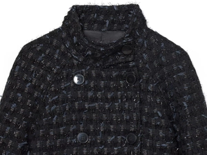 Close-up of black and blue tweed jacket with silver metallic threads and black buttons