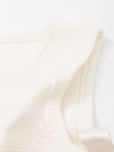 Detailed close-up showing the fine knitted texture and stitching of this white knit vest