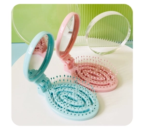 Detail showing portable folding hairbrushes in pastel blue and pink with built-in mirrors