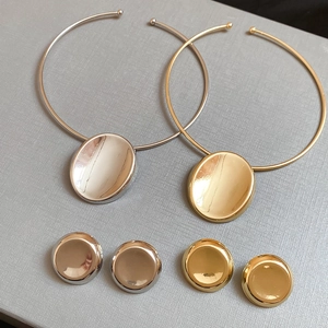 Polished gold and silver oval heart jewelry sets featuring necklaces and matching stud earrings
