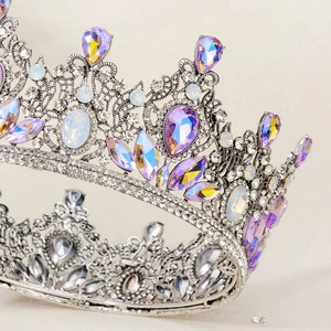 Close-up of vintage Baroque bridal tiara with purple water drop crystals and silver details