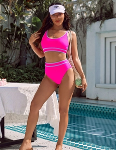 Detail of neon pink bikini set featuring contrast lilac trim and high-waisted athletic cut