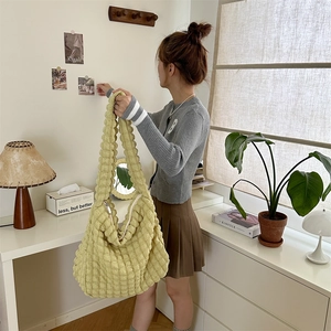 Close-up of the yellow bubble textured fabric and spacious design of the tote bag