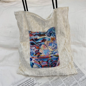 Detailed shot of lace tote bag with artistic colorful abstract print pocket