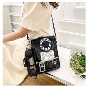 Macro shot of a creative retro telephone purse with black patent leather and dial details