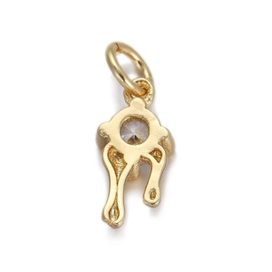 Macro shot of gold-plated S925 sterling silver rabbit charm with clear gemstone inlay