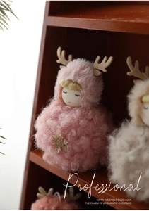 Detail of pink plush Christmas doll with felt antlers and gold snowflake sequins