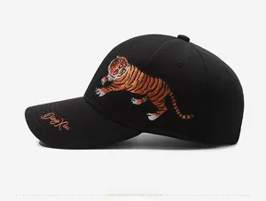 Detailed side view of black baseball cap with vibrant tiger embroidery and Ding Xiu text