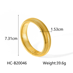 Detail of golden stainless steel wide snake chain bracelet with ribbed texture