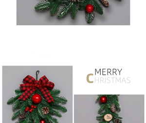 Detail of Christmas wreath with red baubles, pine cones, and snowy needles