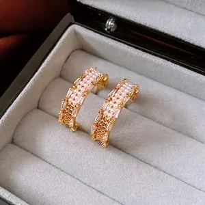 18K gold plated C-shaped earrings with pearls and rectangular zircons in a jewelry box