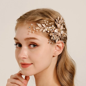 Luxurious gold bridal hair clip with pearls and rhinestones in flower leaf design