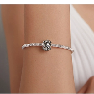 Close-up of s925 silver hollow bead featuring Tree of Life and Family engraving