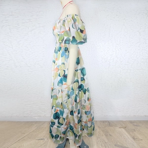Detail of ruffle cuffs and colorful geometric pattern on a high waist maxi dress