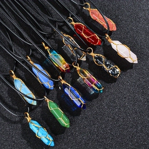 Detailed view of assorted hexagonal crystal pendants with gold wire wrapping and black cords