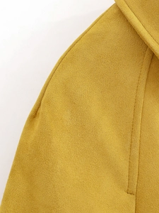 Detailed macro view of ginger yellow suede jacket collar with precise stitching texture