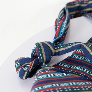 Close-up of ethnic striped woven strap with colorful patterns and sturdy knot detail