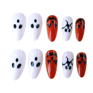 Halloween almond press-on nails featuring cute orange pumpkins and white ghost patterns