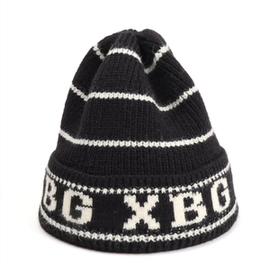 Detail of thick black and white striped knit beanie featuring BG XBG lettering