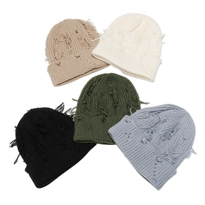 Five distressed knit beanies in various colors including beige, olive, and blue
