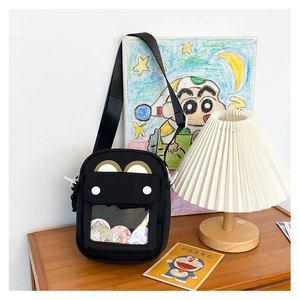 Close-up of black canvas Ita bag with transparent front pocket and cute ear details