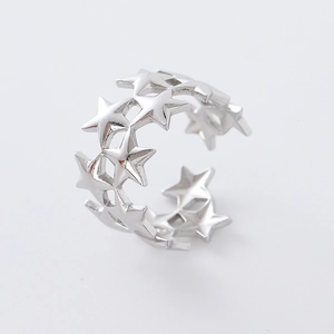 Detail showing polished silver hollow star patterns on this adjustable open ring design