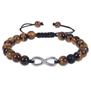 Macro detail of tiger eye beaded bracelet with silver infinity symbol and woven cord